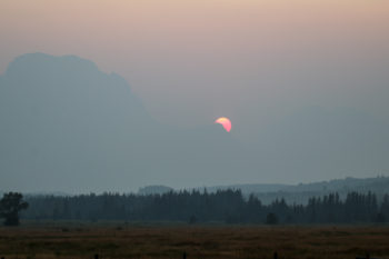Hazy, smoky sunset over the Grand Teton mountain range.